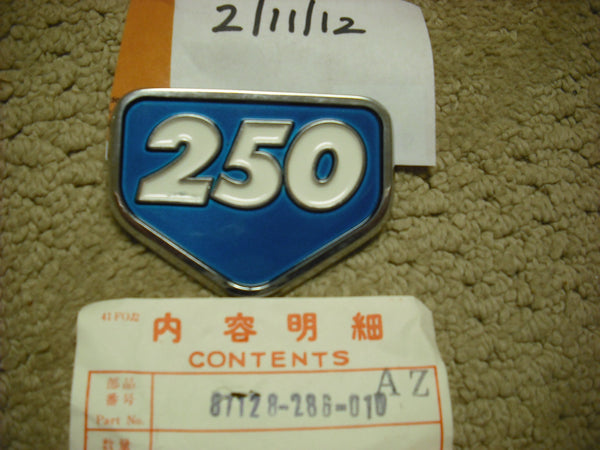 Honda CB250 Aquamarine Sidecover Badge NOS New 871-28-286-010 sku 3112